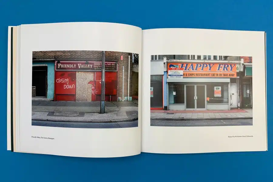 A hands-on view of a photo book with handwritten captions and printed text