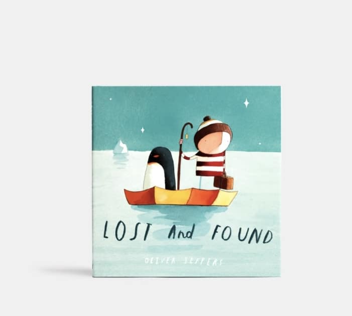 Lost and Found cover with boy and penguin in small boat on a blue sea.