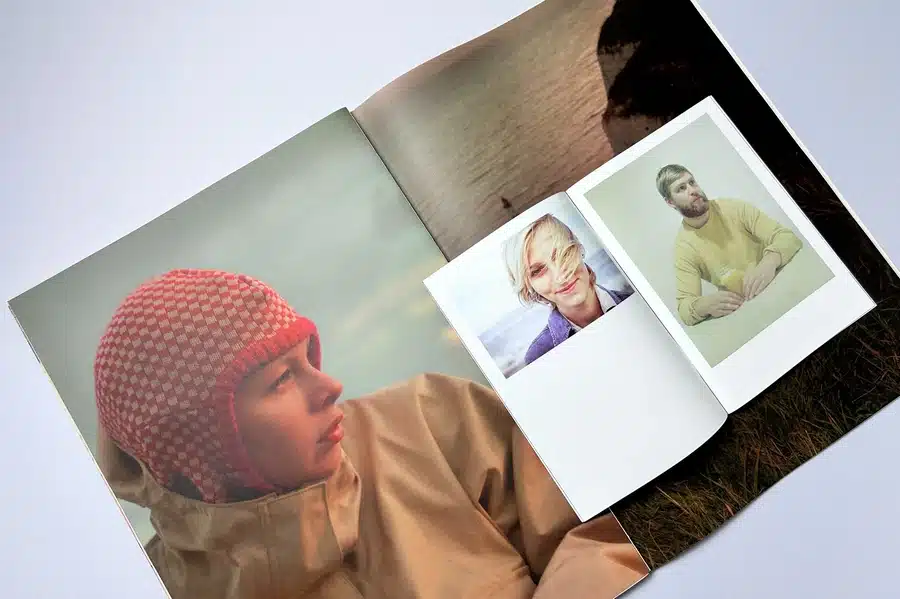 A person creating a personal expression zine, featuring handwritten notes and personal photos.