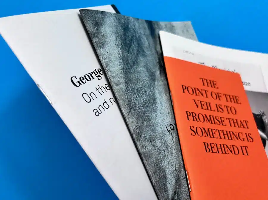 Close-up of saddle stitch binding on a booklet printed at Ex Why Zed