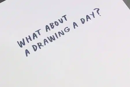 Close-up of an artist inking and adding colour to a comic panel for printing at Ex Why Zed