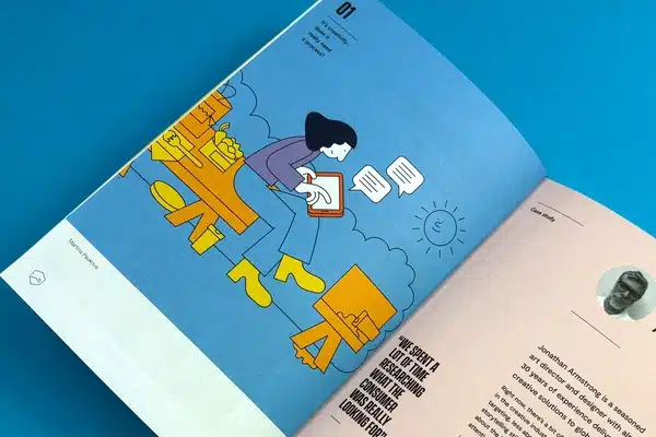 An artist exploring a collection of comic books printed at Ex Why Zed for research and inspiration