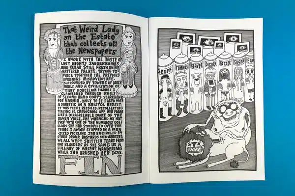 An artist exploring a collection of comic books printed at Ex Why Zed for research and inspiration