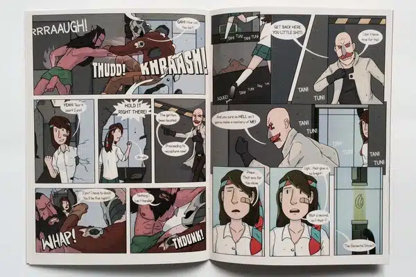 An artist exploring a collection of comic books printed at Ex Why Zed for research and inspiration