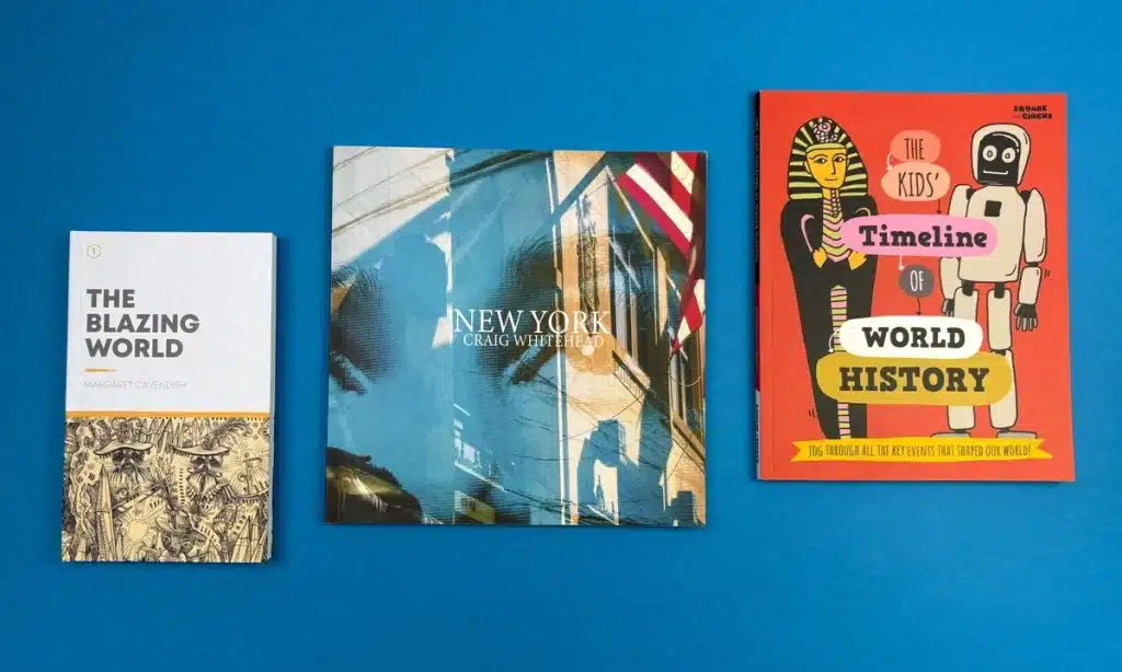 A stack of professionally printed books with “Self-Publishing Success” written on the cover