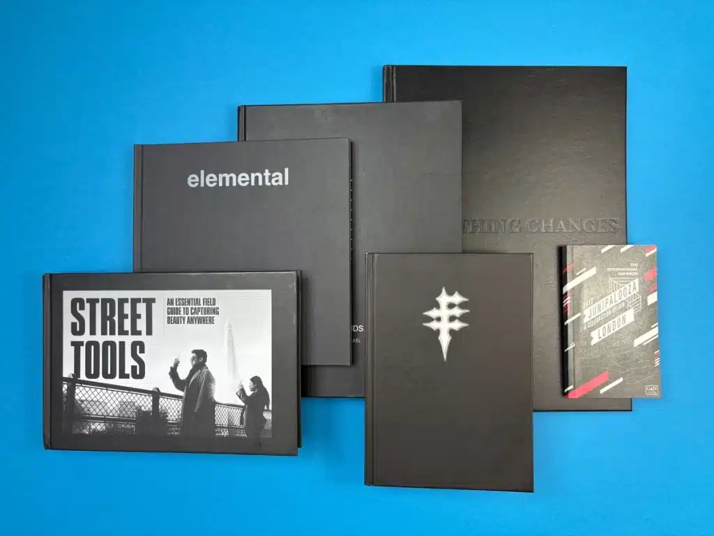 Books in popular standard and custom sizes printed by Ex Why Zed laid flat to illustrate marketable book dimensions.