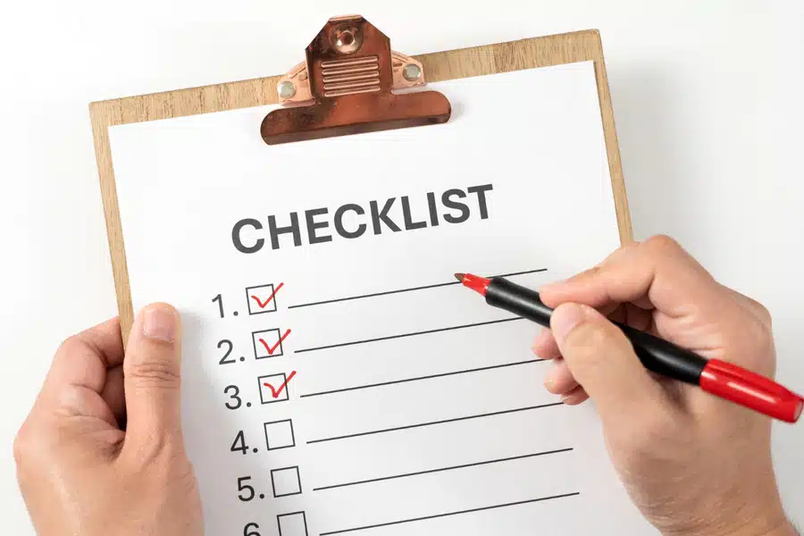 A self-published author checking off items on a book publishing checklist