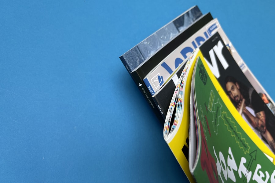 Magazine binding methods comparison – perfect bound and saddle stitched options