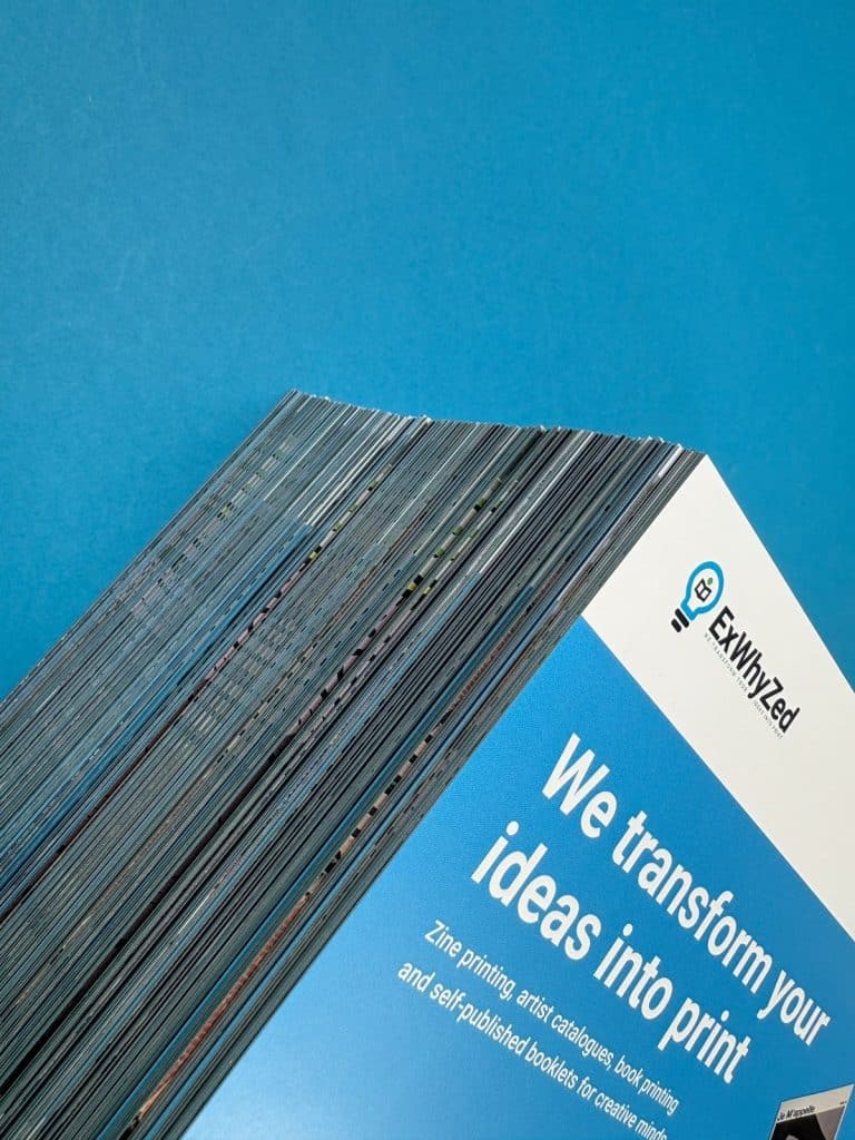 Examples of zine paper types including matte, glossy, and recycled options for printing