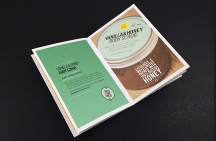 Product brochure opened to inner spread showing clear layout and two-page design by Ex Why Zed