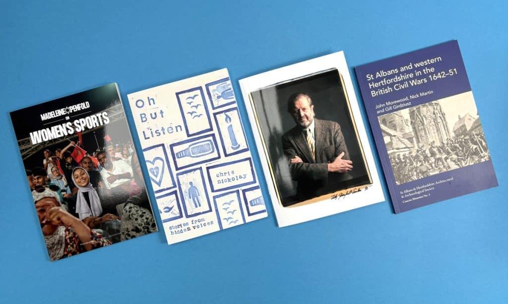 Premium paperback and hardcover books printed by Ex Why Zed on a blue background
