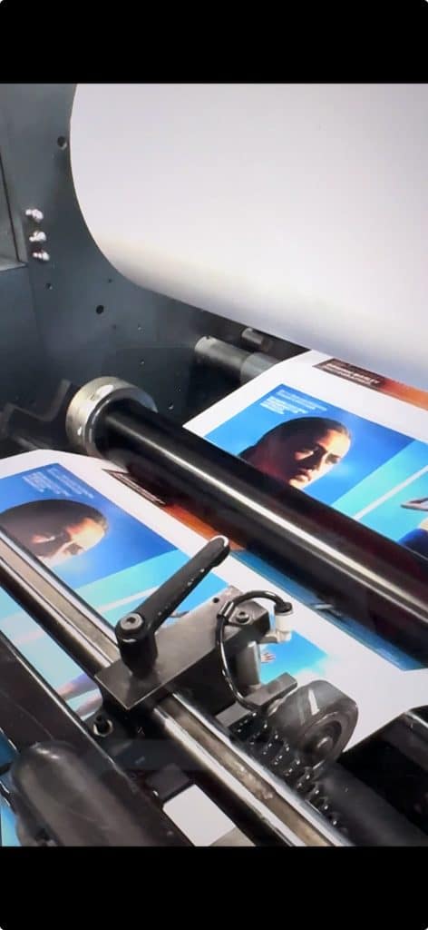 Photobook pages running through an Ex Why Zed press during production, showing colour-managed printing in action.