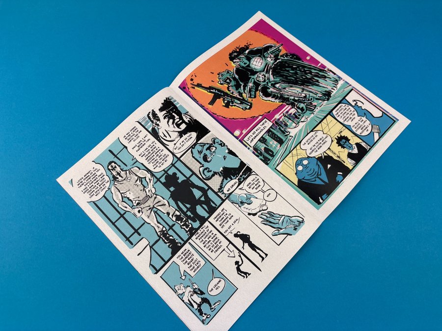 Comic page with sequential panels and speech bubbles on a blue background, showing structured storytelling and pacing in print.