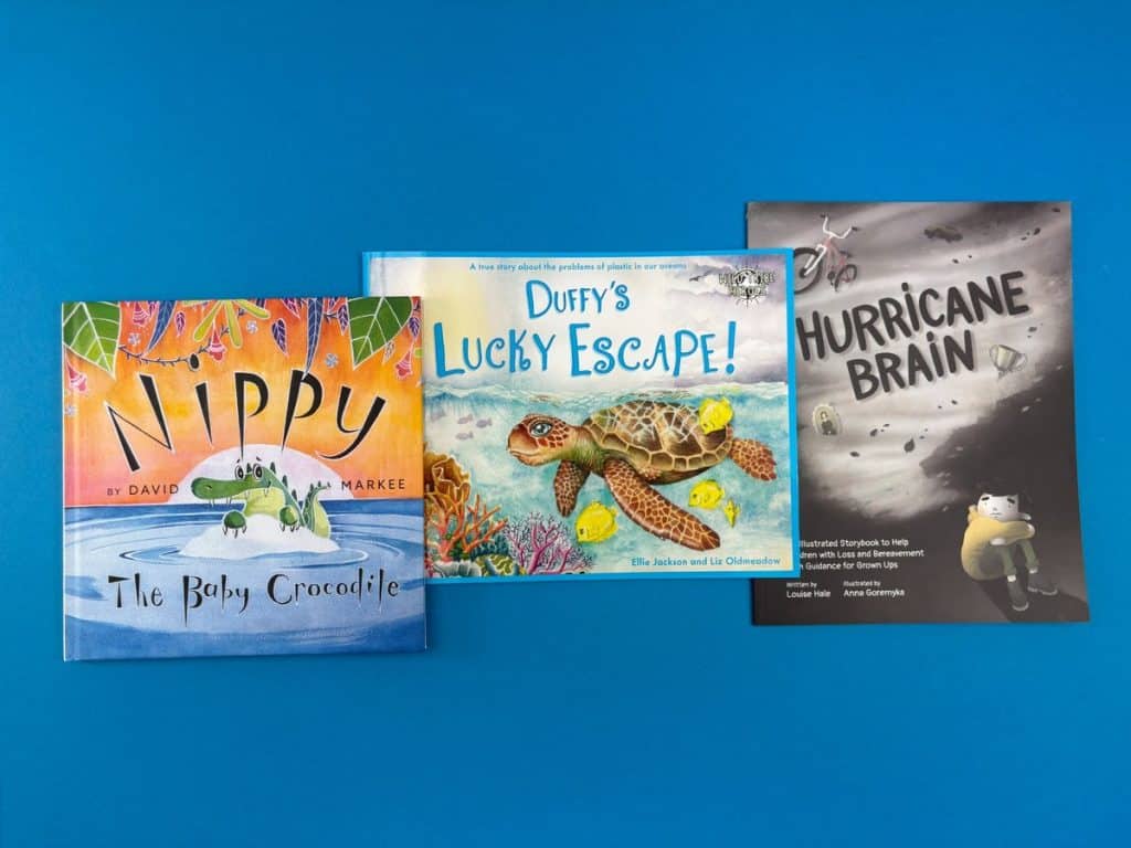 Collection of printed children’s books, illustrated spreads and writing guides showing how to write a children’s book and prepare it for print.