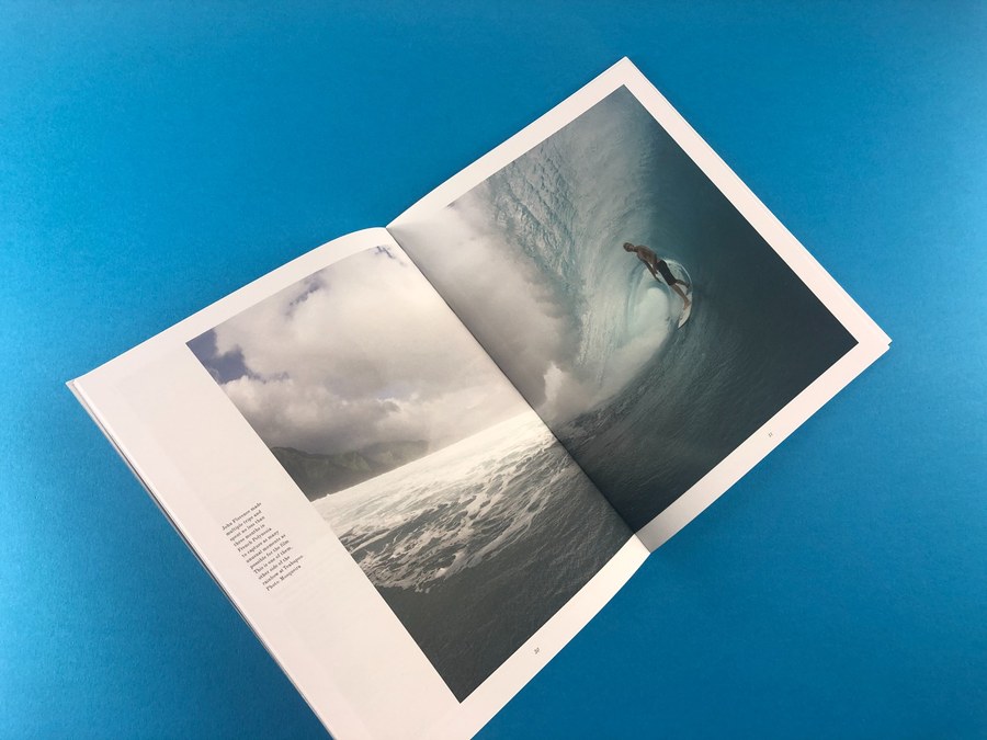 Open black and white photo book spread showing sharp print detail on a blue studio background.