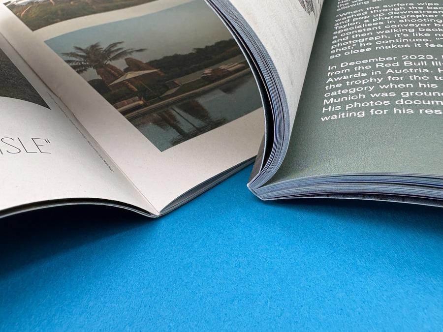 Close-up of open printed magazines showing paper depth, binding and production choices that influence final pricing.
