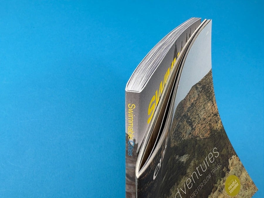 Side view of a perfect bound magazine showing its square spine, page block and flexible printed cover.