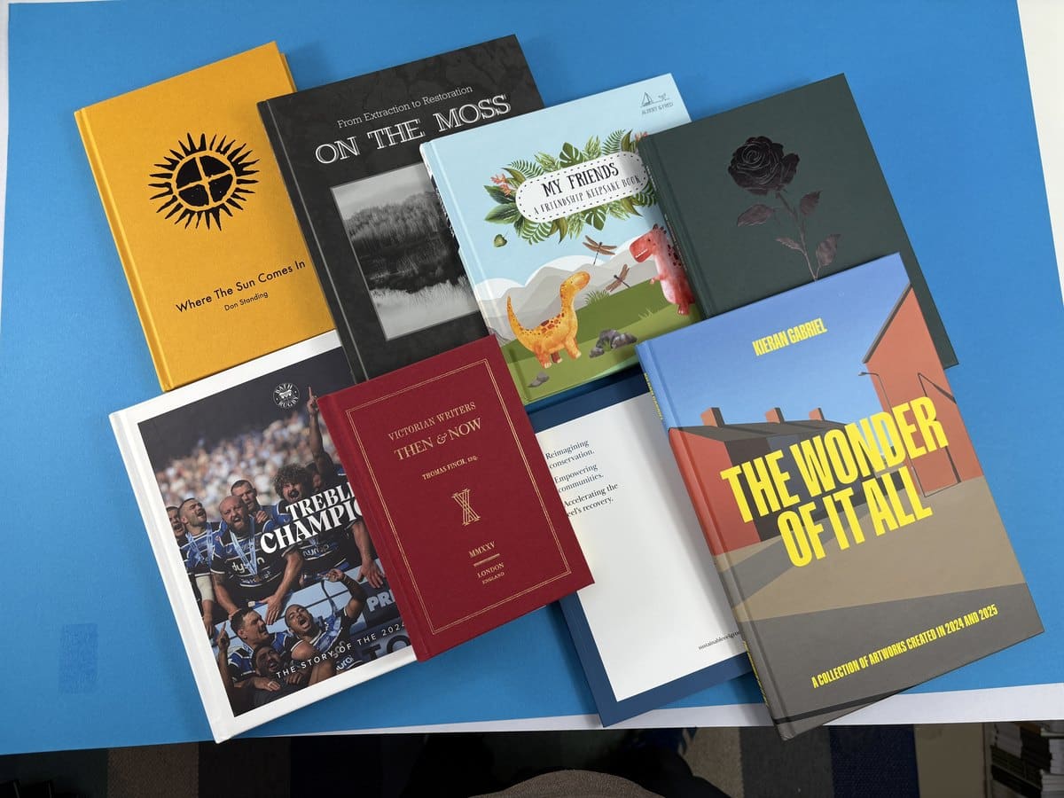 A collection of case bound hardback books printed by Ex Why Zed, showing different cover materials, spine widths and finishes.