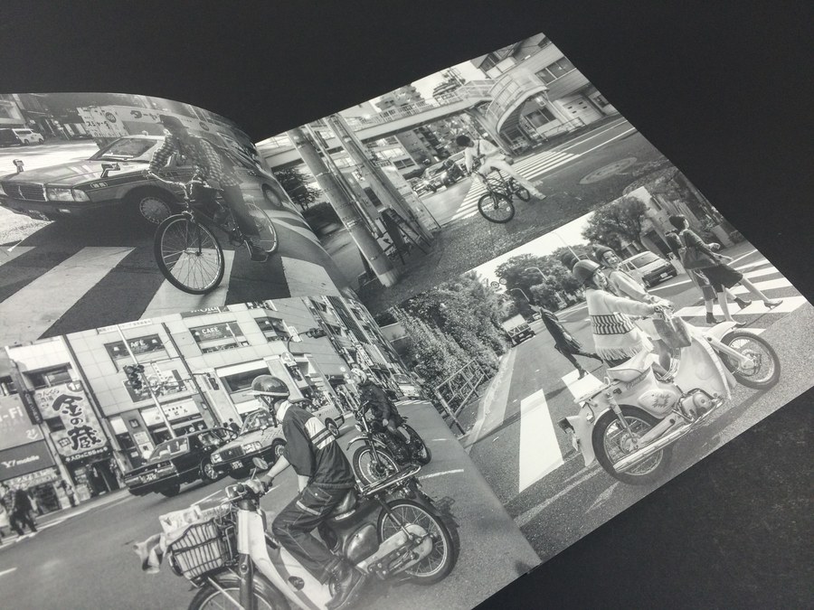 A black and white photo zine open on a double page spread, showing the grain and contrast a good zine printer preserves.