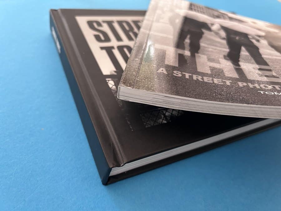 Close-up of a case bound photography book with a perfect bound edition, showing spine construction and print finish quality.
