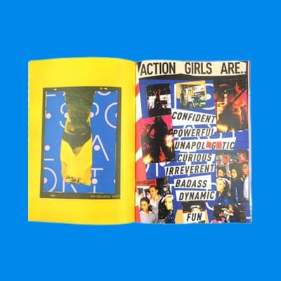 An open saddle-stitched zine spread from Action Girls Magazine, showing full-colour collage artwork