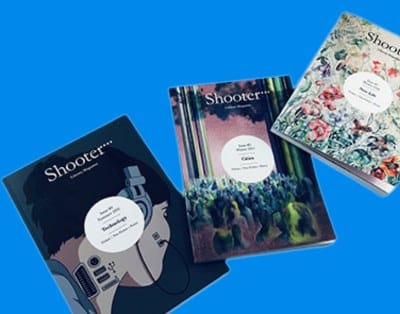 Three issues of Shooter literary magazine printed by Ex Why Zed, showing a consistent zine format and size