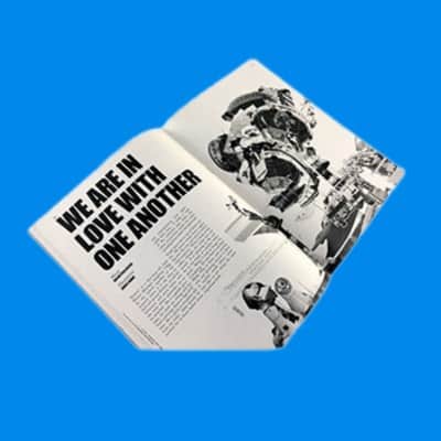 An open black and white zine spread titled We Are In Love With One Another, printed on uncoated paper