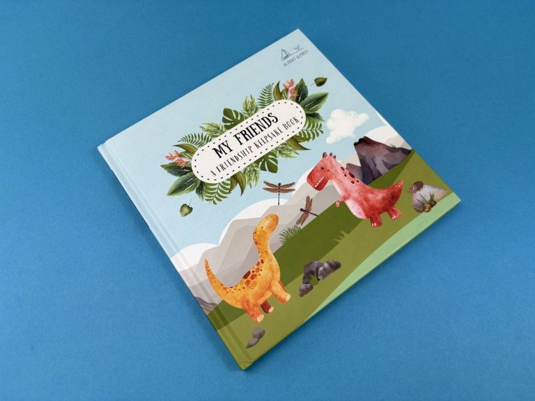 Dinosaur edition of My Friends, a 210×210mm hardback friendship keepsake book, laminated cover angled on a blue backdrop.