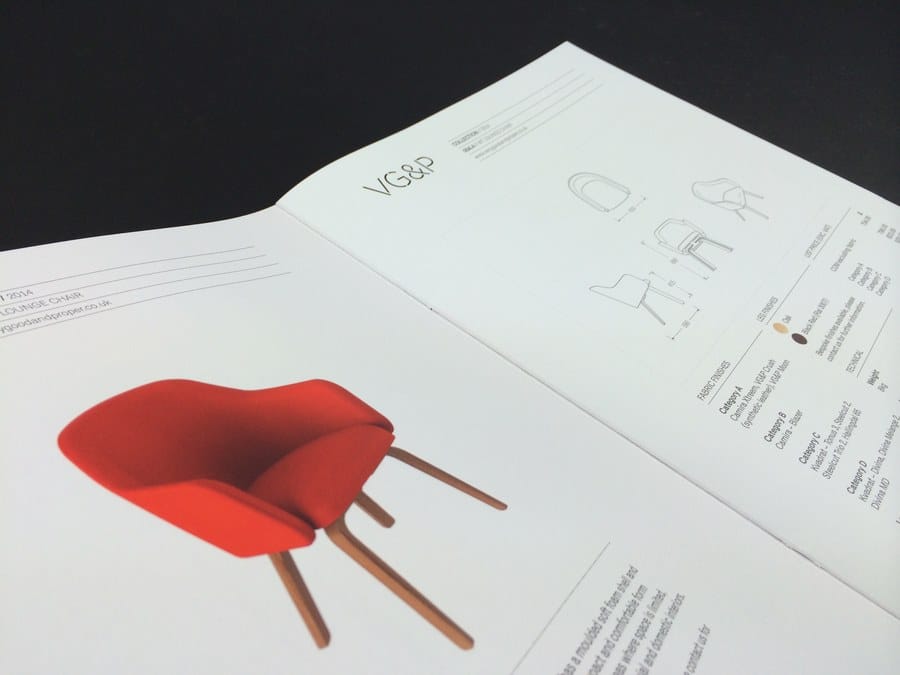 An open furniture catalogue showing a red chair photograph beside technical line drawings and dimensions