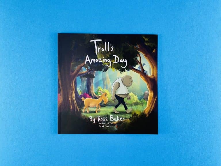 Square children’s picture book cover of Troll’s Amazing Day, a troll and a golden goat walking through a dark forest.